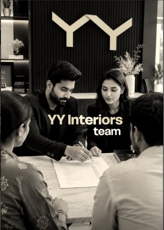 The YY Interiors team going through a plan with clients across a marble table